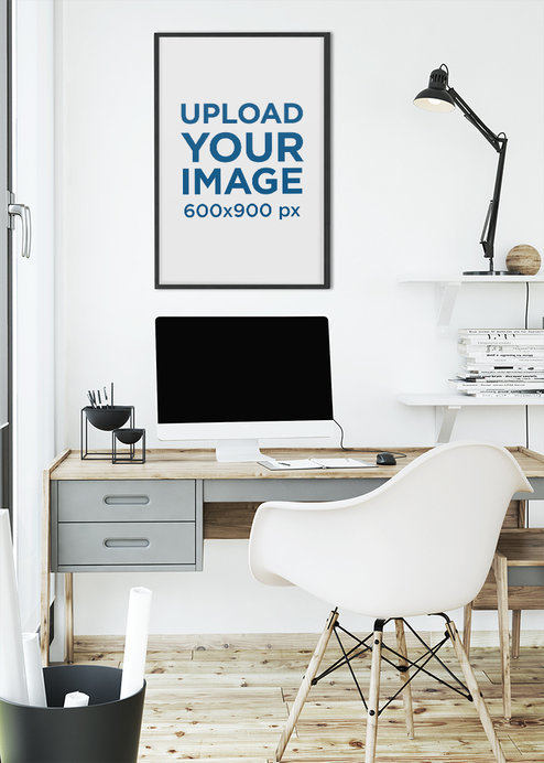 Mockup of an Art Print Frame Hanged by a Modern Desk