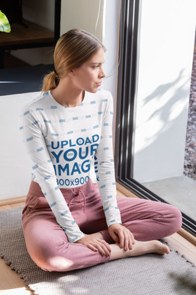 Sublimated Long Sleeve Tee Mockup of a Young Woman Sitting Next to a Window