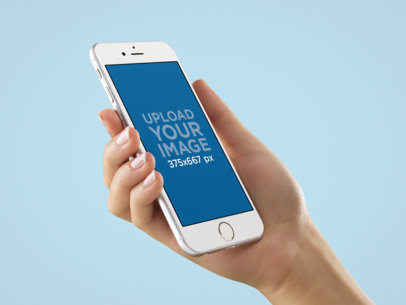 Angled White iPhone 6s Mockup Held in Hand by a Woman Over a Null Background
