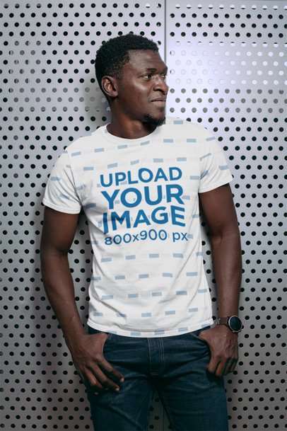 Sublimated Tee Mockup Featuring a Man Against a Grid Wall