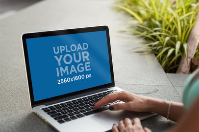 MacBook Pro Mockup Featuring a Woman Using Her Computer 