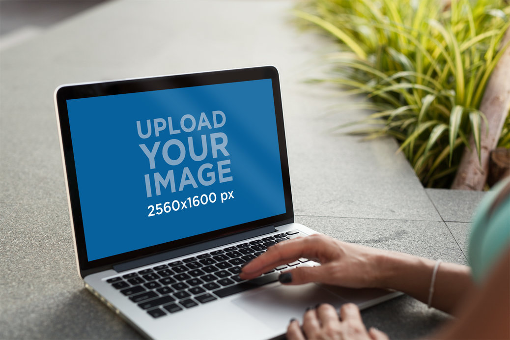 Placeit - MacBook Pro Mockup Featuring a Woman Using Her Computer
