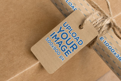 Mockup of a Cardboard Brand Tag Tied to a Kraft Wrapping Paper Roll 1300-el1