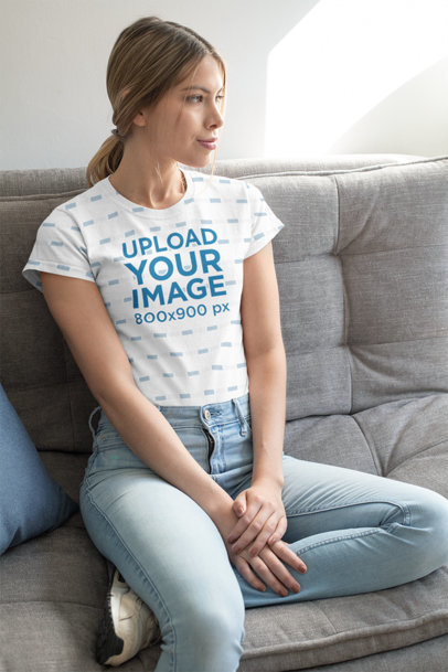 Mockup of a Woman Wearing a Sublimated Tee at Her Home