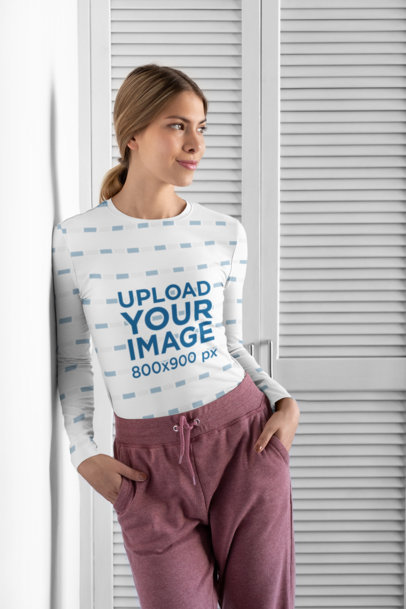Sublimated Long Sleeve Tee Mockup Featuring a Woman Leaning Against a Wall 