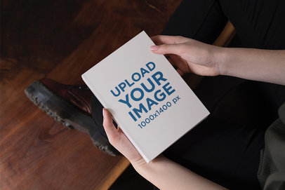 Mockup of a Woman Holding a Hardcover Book in Her Hands 2353-el1