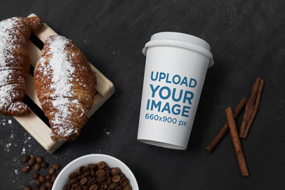 Mockup of a Coffee Cup Placed by Some Pastries