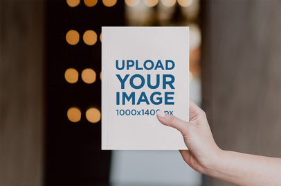 Mockup of a Woman's Hand Holding a Paperback Book 2354-el1