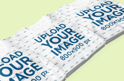 Mockup of Three Folded Sublimated T-Shirts on a Flat Surface