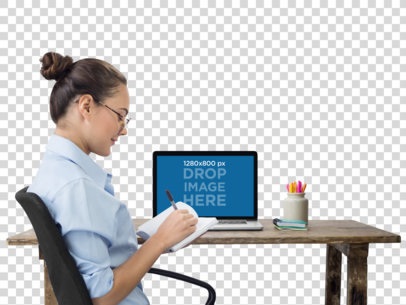 MacBook Mockup of an Office Woman Writing in Her Notebook