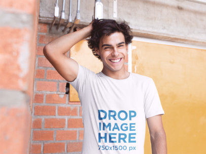 T-Shirt Mockup of a Guy Smiling and Grabbing His Hair