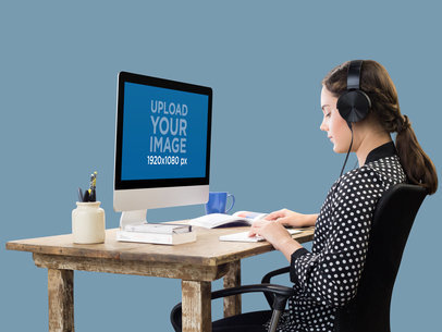iMac Mockup of a Woman Working While Listening to Music