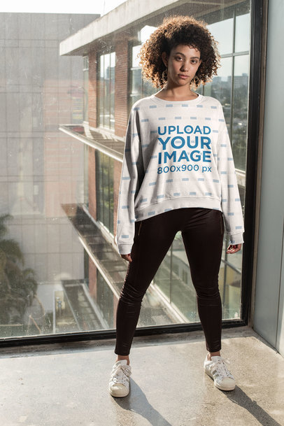 Mockup of a Curly-Haired Woman Wearing a Sublimated Sweatshirt
