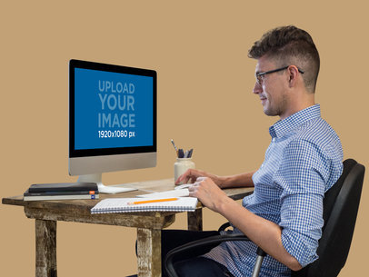 iMac Mockup of a Man Working at His Desk