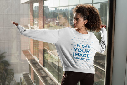 Mockup of a Woman with an Oversized Crewneck Sweatshirt Posing by a Window
