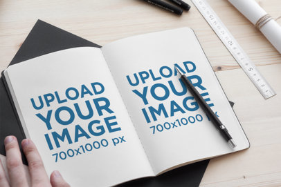 Sketchbook Mockup Featuring a Man Ready to Write 2339-el1