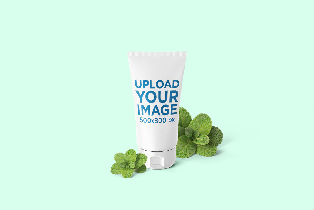 Mockup of a Cosmetic Tube Surrounded by Fresh Mint Leaves