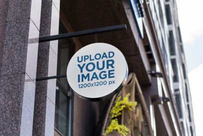Mockup of a Circular Sign Placed on a Modern Building 