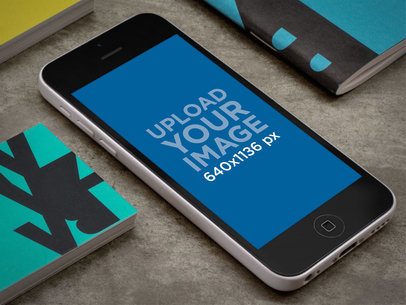 iPhone 5c Mockup Featuring a Concrete Table
