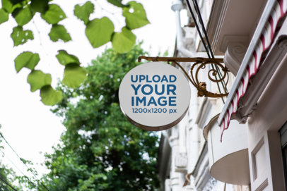 Mockup of a Round Sign Attached to a Building 