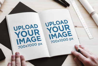 Sketchbook Mockup Featuring a Man's Hands and a Wooden Work Desk 2340-el1