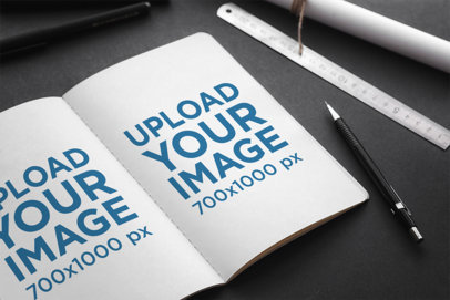 Mockup Featuring an Open Sketchbook Placed on a Dark-Colored Desk 2342-el1