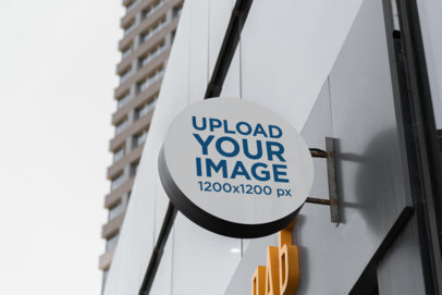Mockup of a Round Sign on a Dark Modern Building