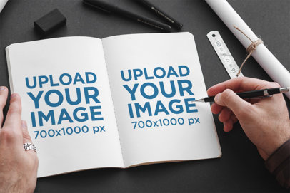 Mockup of a Person Drawing on a Sketchbook 2343-el1