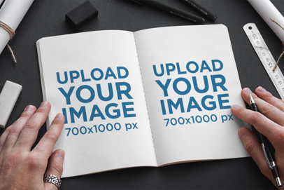 Sketchbook Mockup Featuring a Dark-Colored Desk a Man Ready to Draw 2344-el1