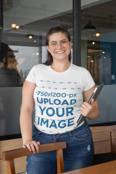 Plus Size Tee Mockup of a Smiling Woman Holding a Laptop