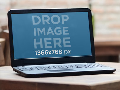 Mockup of a Laptop Placed on a Rustic Table