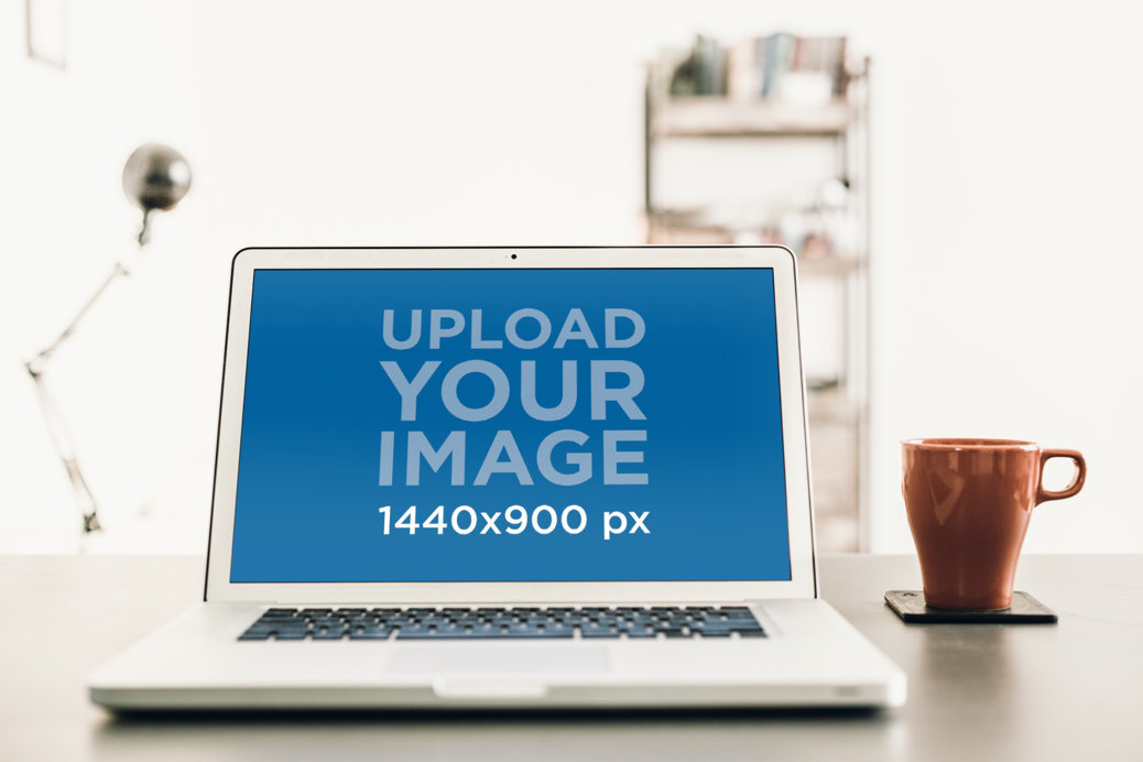 Mockup Featuring a MacBook Pro Placed on a Desktop
