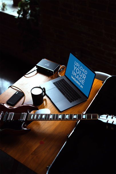 MacBook Pro Mockup Placed Next to a Guitar 