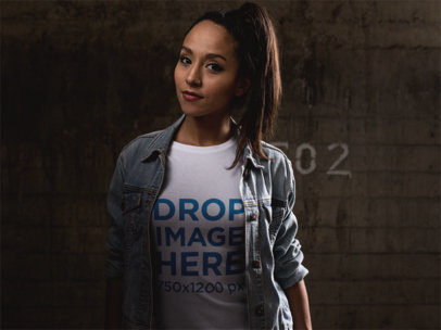 Tee Mockup of a Woman Wearing a Denim Jacket at Night