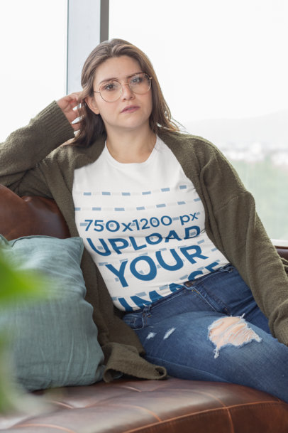 Plus Size T-Shirt Mockup Featuring a Woman Relaxing on a Couch 