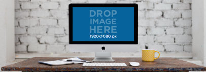 iMac Mockup on a Wood Desk in Front of a White Brick Wall