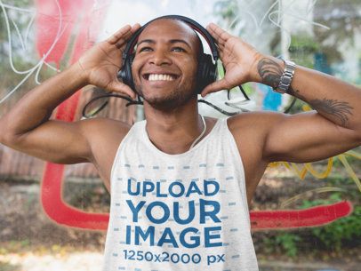 Smiling Man Wearing a Tank Top and Headphones in the Street