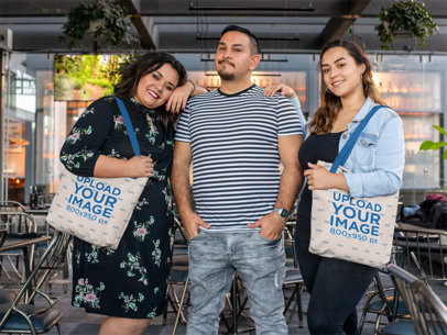 Tote Bag Mockup Featuring Two Women Posing with Their Friend