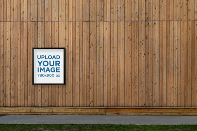 Mockup of a Poster Display Case Placed on a Wooden Wall by a Street 