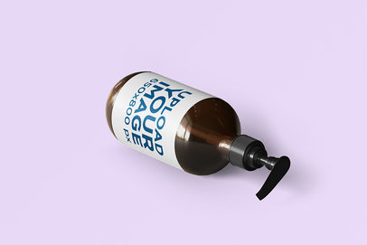  Mockup Featuring a Dispenser Bottle Lying on a Solid Color Surface 
