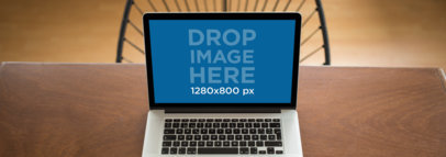 Wide Shot MacBook Mockup Over a Wooden Table