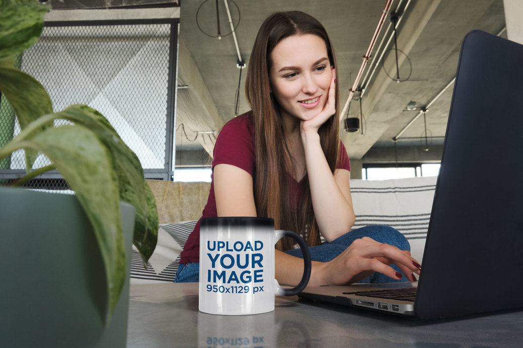 11 oz Magic Mug Mockup Featuring a Woman Using Her Laptop