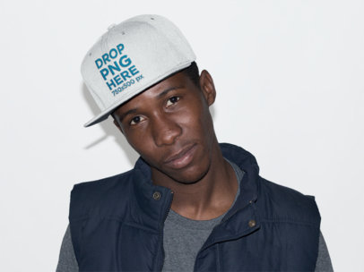 Young Man Wearing a Snapback Hat in a Studio Mockup