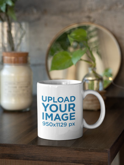 Mockup of an 11 oz Coffee Mug Next to Some Home Decorations 