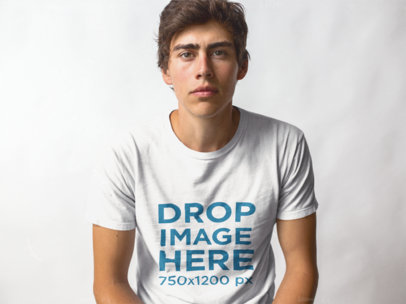 Trendy Guy Sitting in a Studio Wearing a T-Shirt Mockup