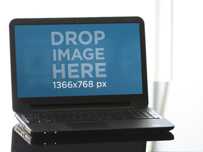 Mockup Featuring a Laptop Placed on a Desk 