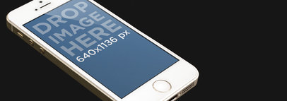 Mockup of an iPhone 5s Gold in Portrait Position Lying on a Dark Surface 