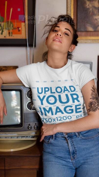 T-Shirt Video Featuring a Tattooed Woman Posing by a Retro TV 