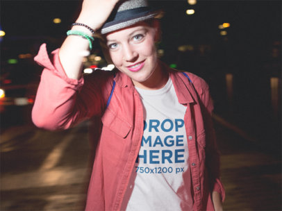 Mockup of a Stylish Woman Wearing a Tee and Hat Out at Night a11802