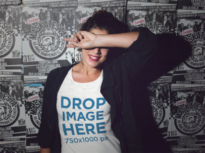 Tee Mockup of a Young Woman Against a Poster Wall at Night a11809